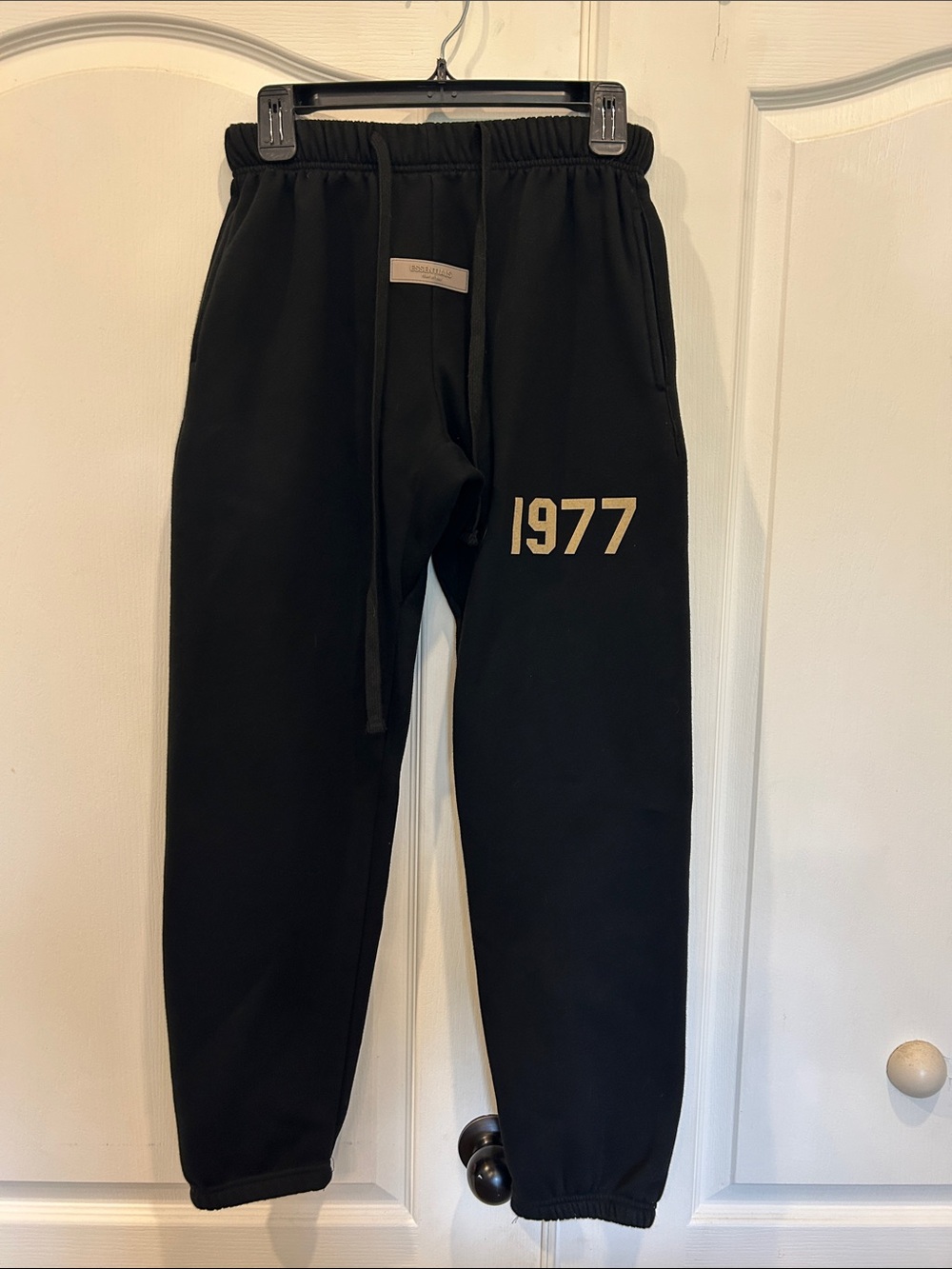 Fear of God Essentials Black Sweatpants with Gold '1977' Print FOG Sweats